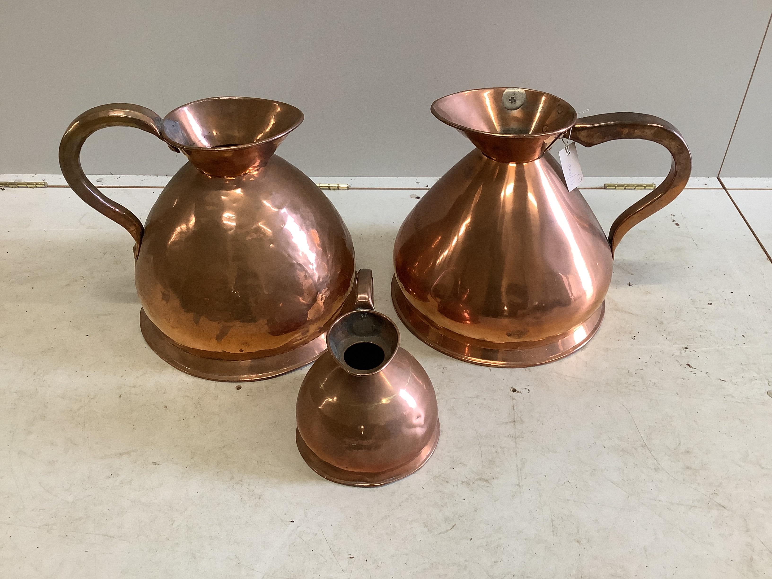 Two Victorian copper four gallon haystack measures, one engraved “Empire Palace” and a half gallon measure, largest height 41cm
